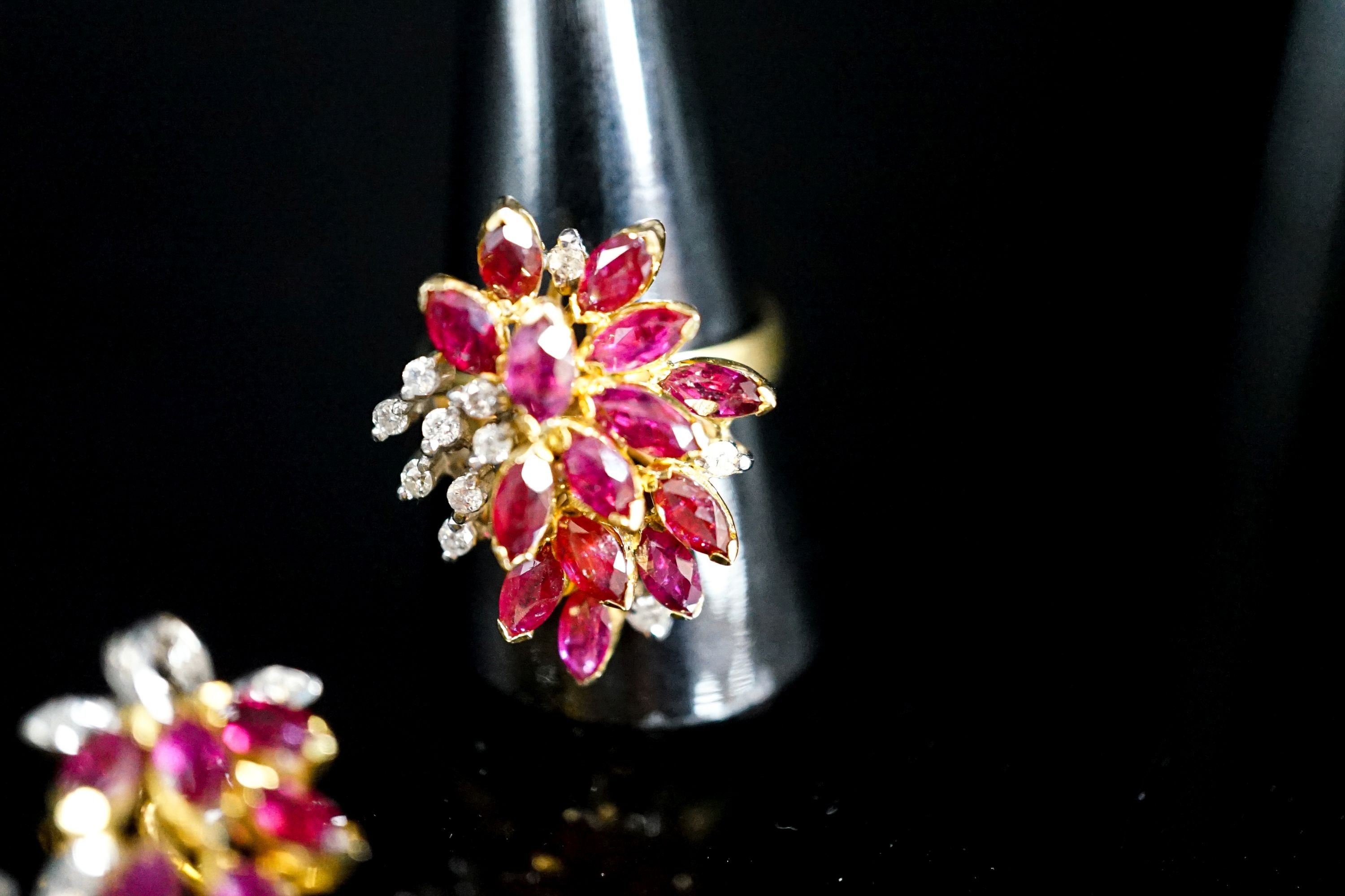 A modern 585 yellow metal, ruby and diamond cluster dress ring, size T and a pair of matching earrings, gross 14.1 grams.